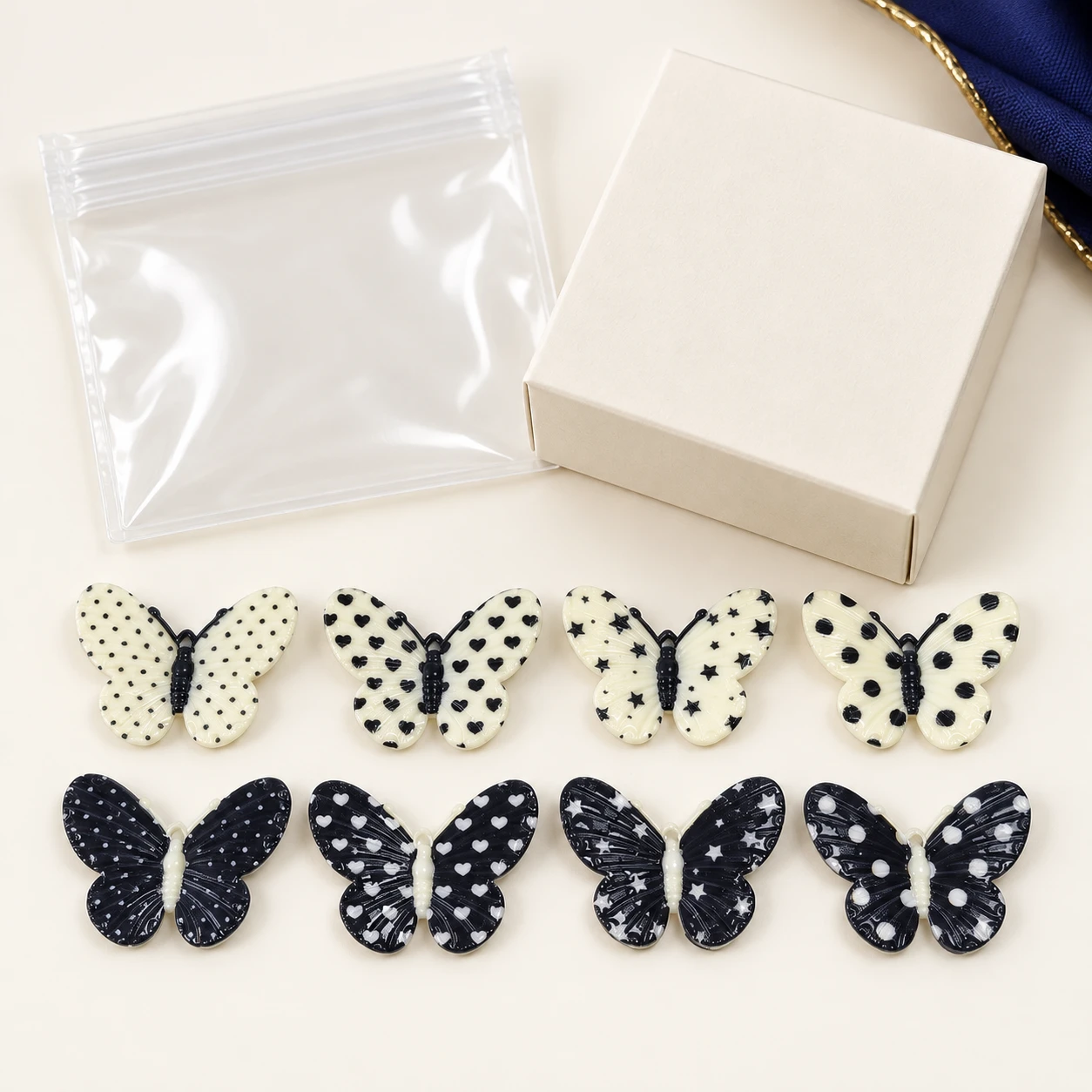 Black and White Spotted Butterfly Resin Charms RW002637 with illustrative private-label packaging