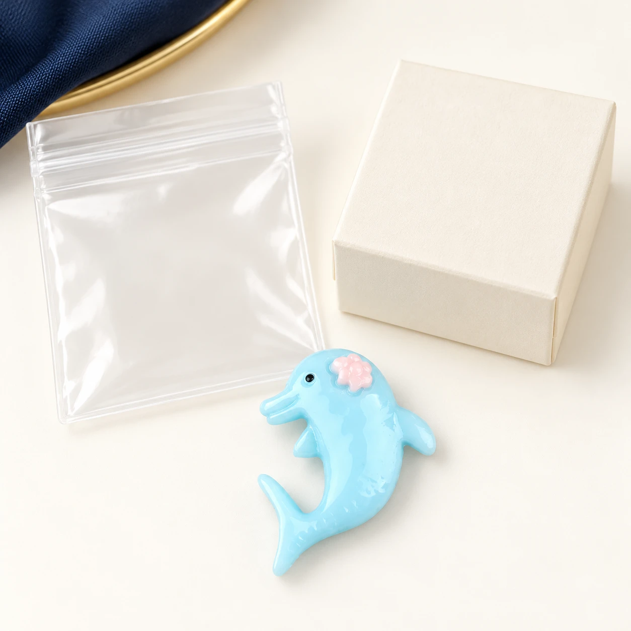 Blue Dolphin Resin Charm RW001078 with illustrative private-label packaging