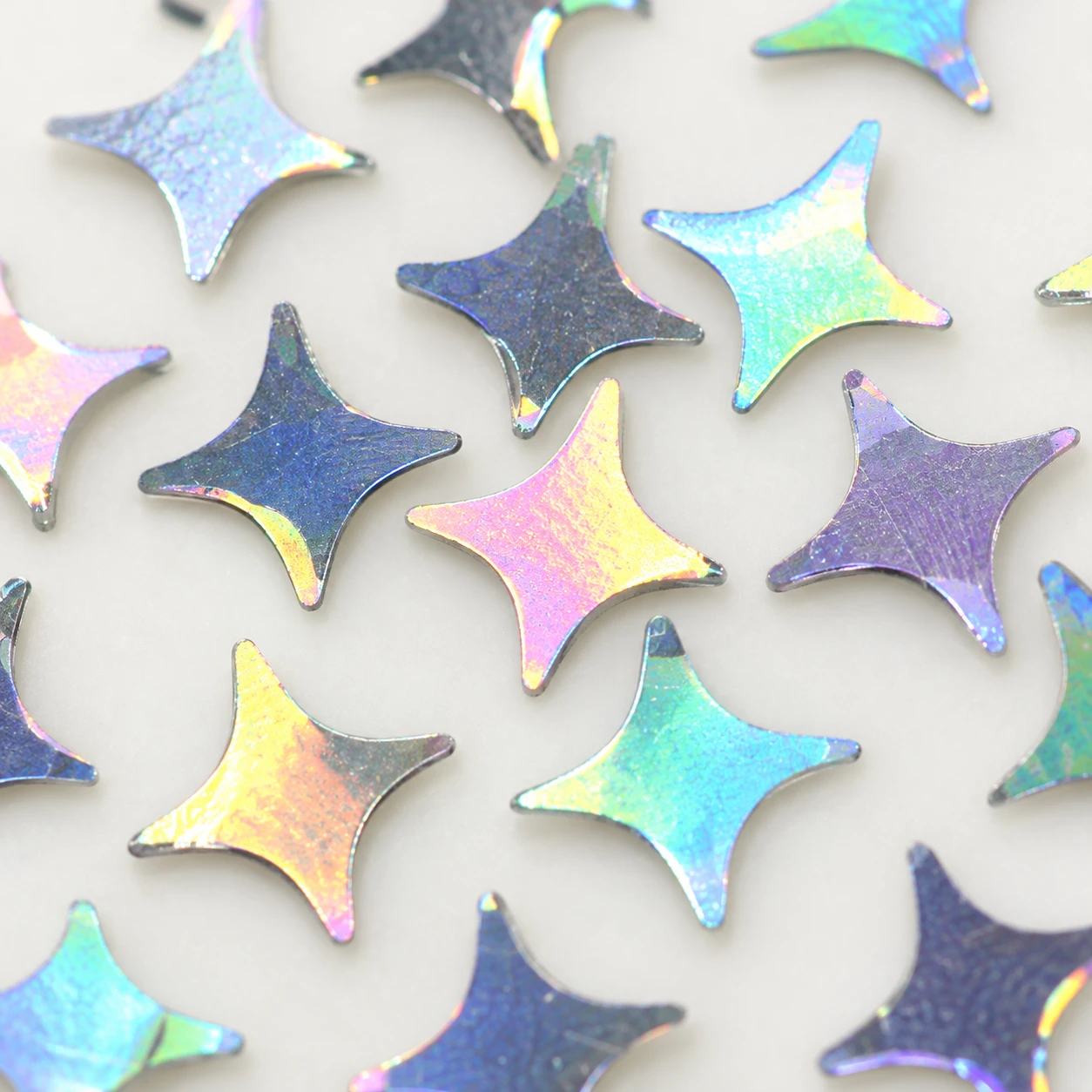 Iridescent Four-Point Star Sequins MA033 close-up showing the decorative shape and finish