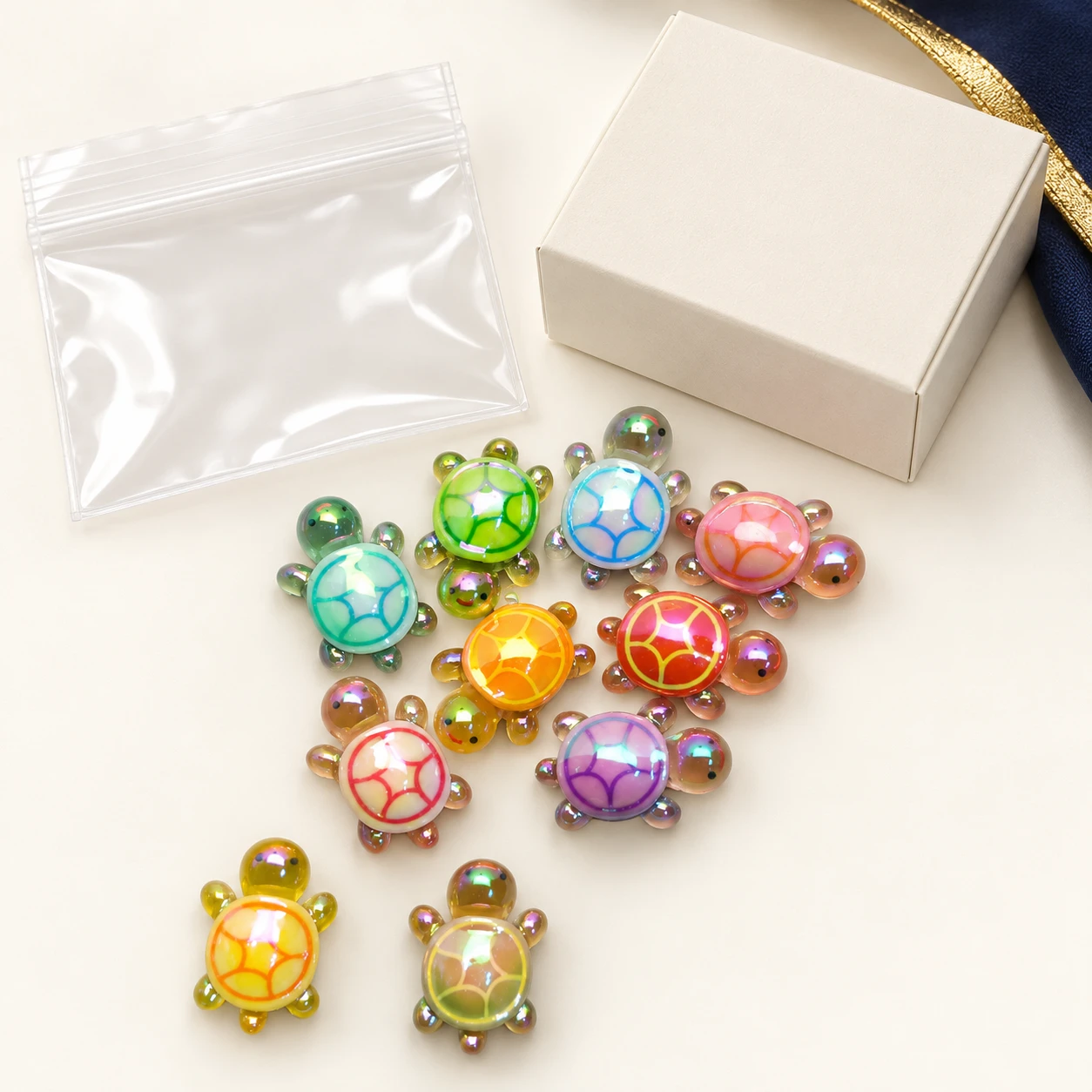 Iridescent Mini Turtle Resin Charms RW0026057 with illustrative private-label packaging
