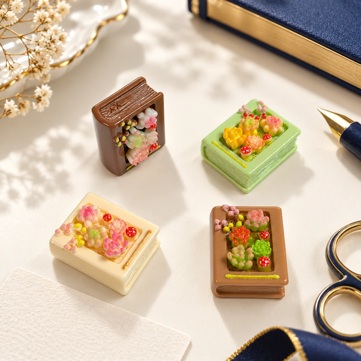 Mini Book and Succulent Resin Charms RW002201 / 26668 in an illustrative craft workspace