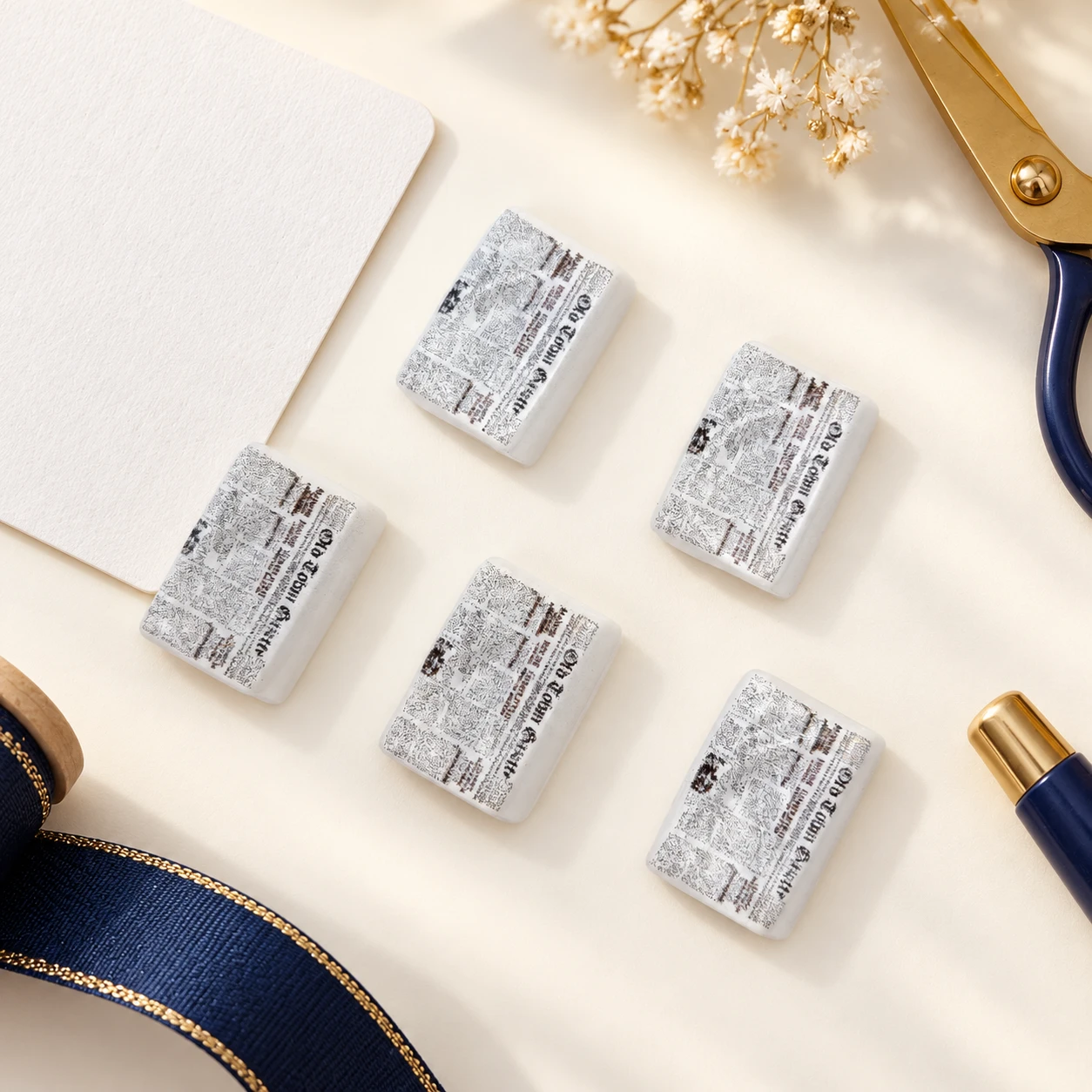 Mini Newspaper Resin Charms RW001857 in an illustrative craft workspace