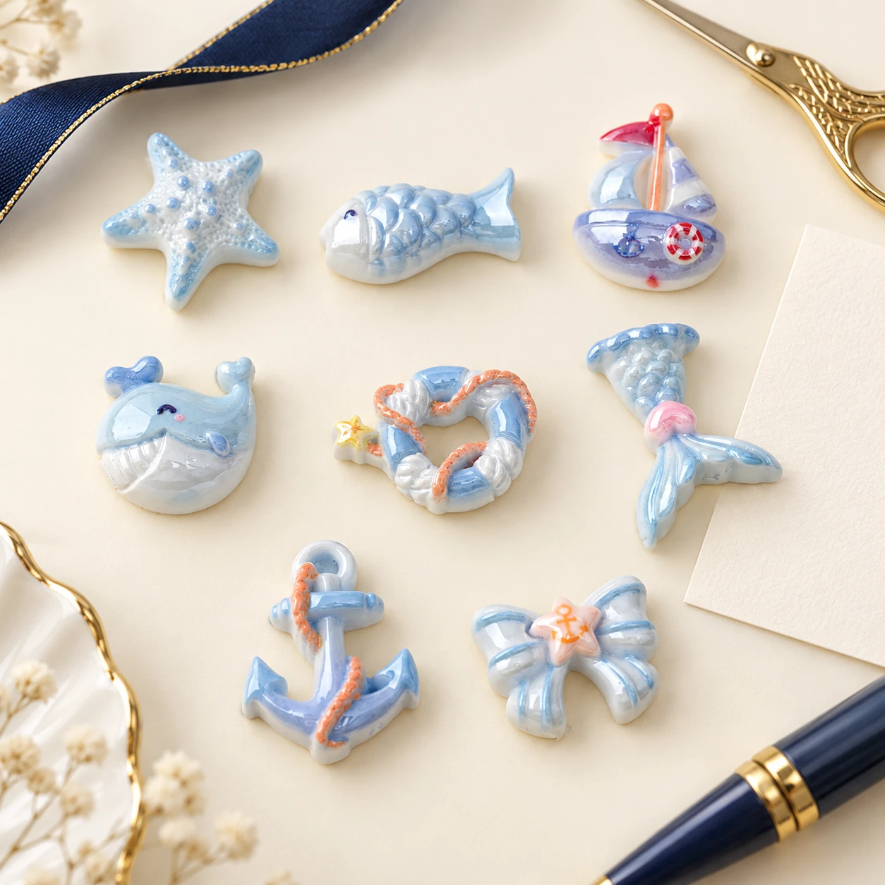 Ocean Mermaid Tail and Whale Resin Charms RW00686 in an illustrative craft workspace
