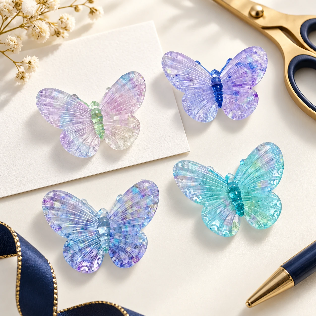 Pastel Iridescent Butterfly Resin Charms RW002654 / RW26619 in an illustrative craft workspace