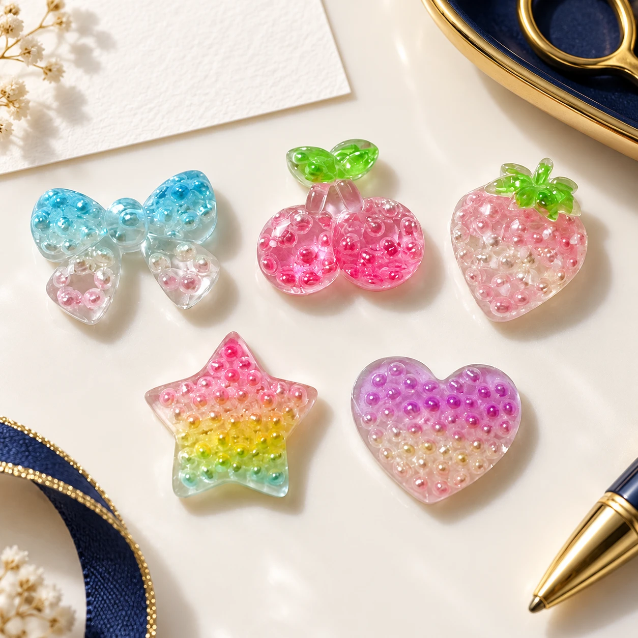 Pearl-Effect Fruit Heart and Star Resin Charms RW003334 in an illustrative craft workspace