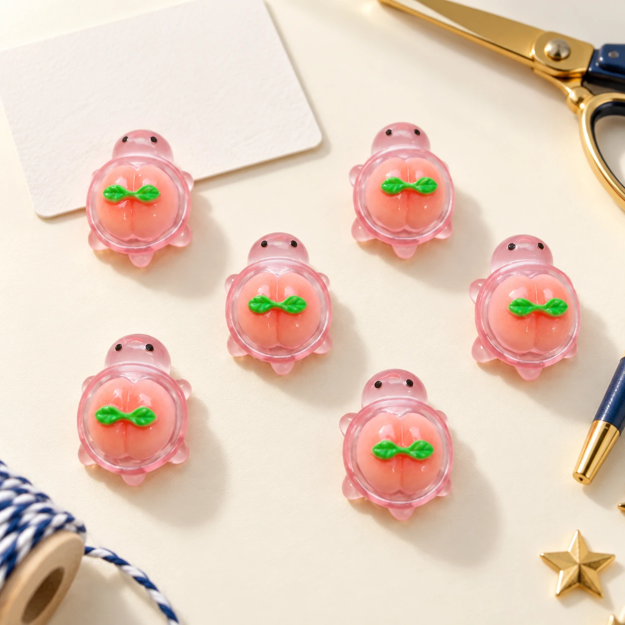 Pink Peach Turtle Resin Charms RW003390 in an illustrative craft workspace